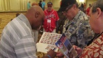 Former White Sox player signs autographs for SABR 45 attendees.